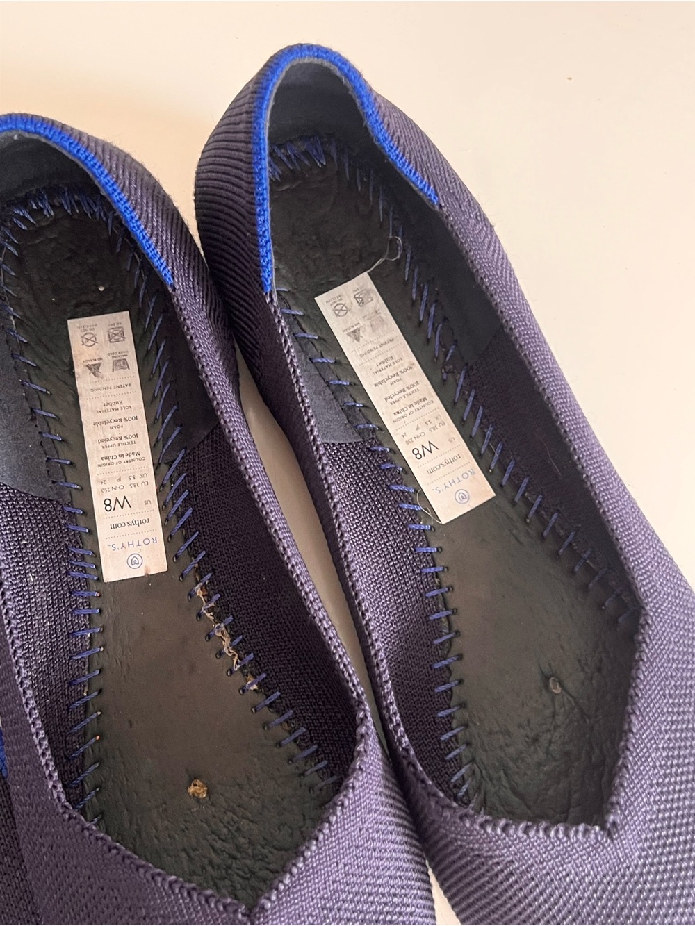 Rothy's navy blue round-toe knit flat shoes featuring a distinctive bright blue - Picture 5 of 12